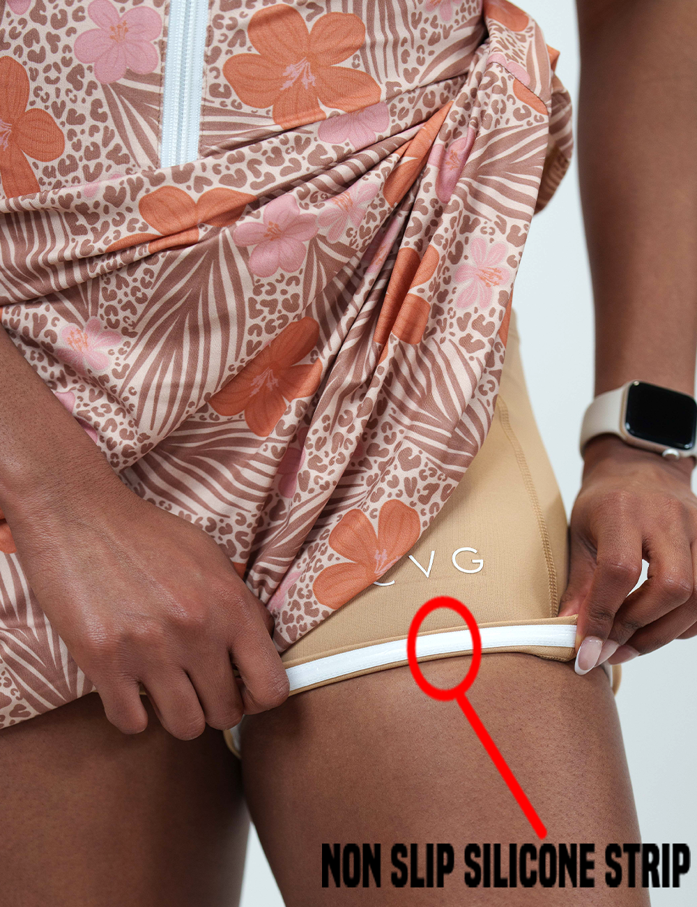 close up of the leopard and flower dress rolled up to show the non slip silicone strip lining found in the shorts underneath the dress