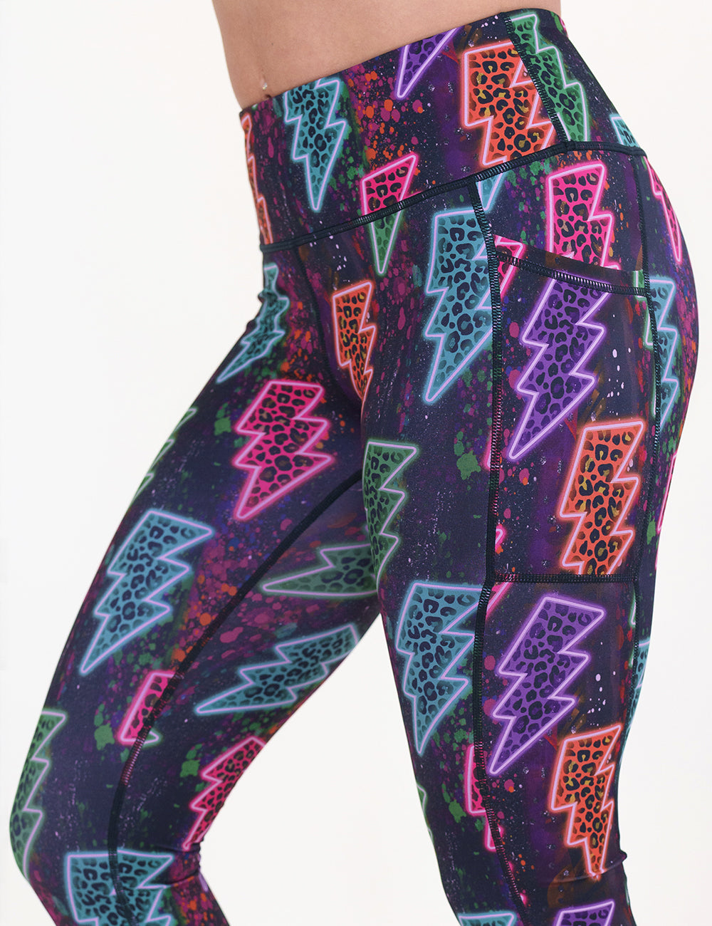 front of the neon thunderbolts patterned leggings against a white background