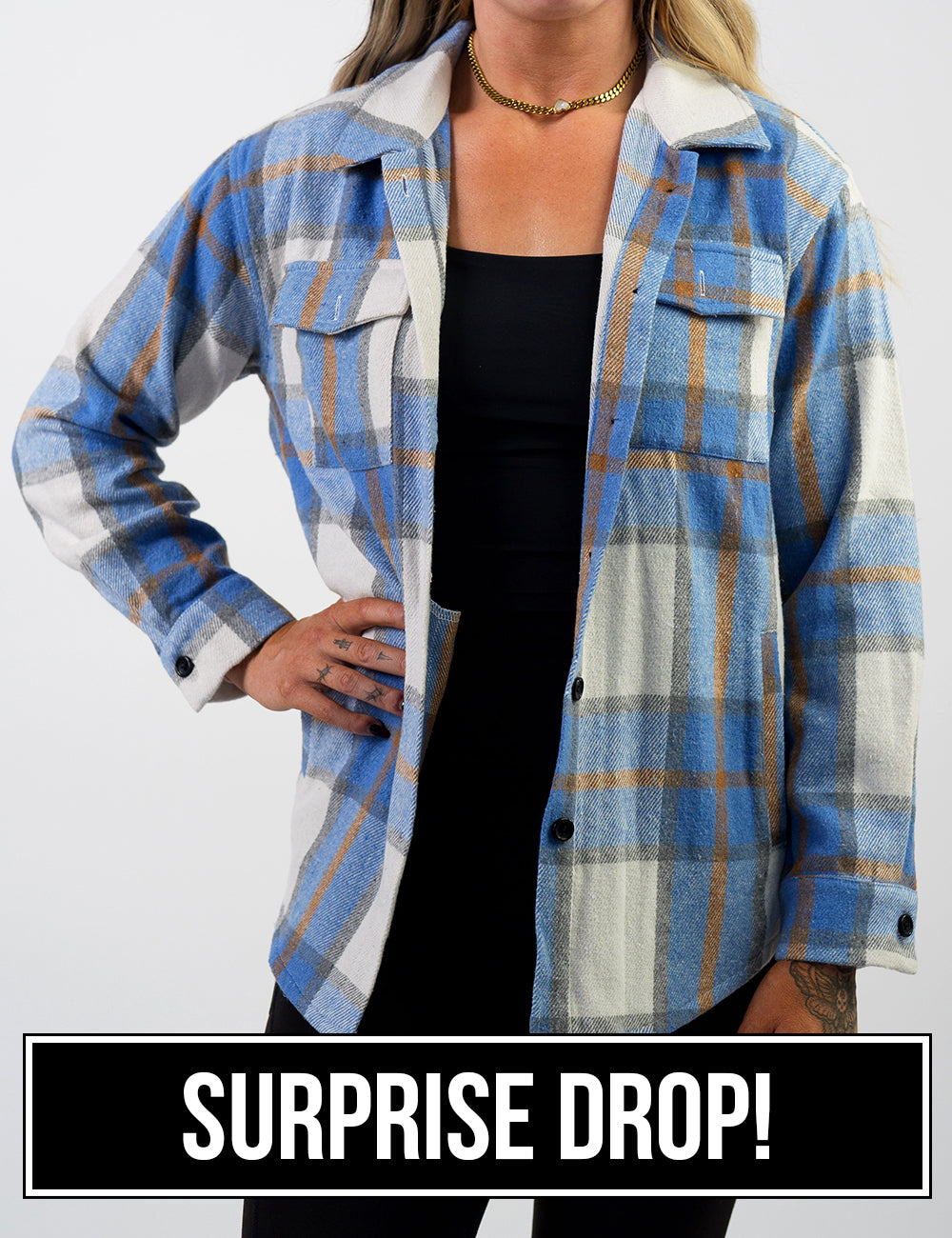 front of the light blue, white, grey, and gold shacket surprise drop