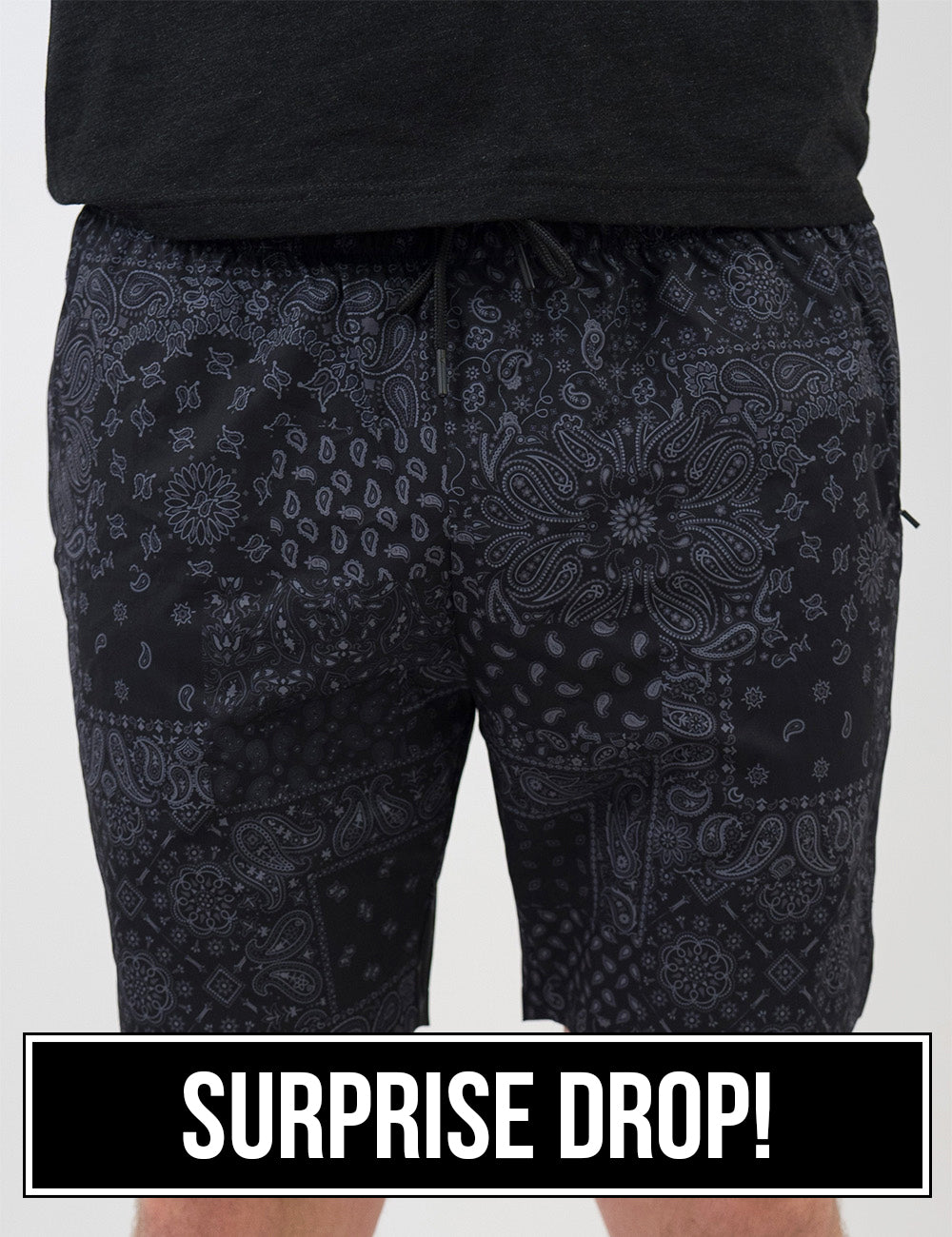 front of the black men's shorts with a grey paisley pattern against a white background, surprise drop