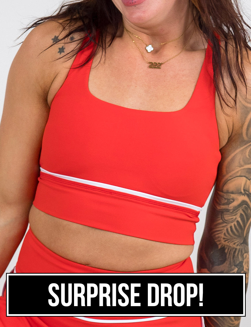 front of the red with white accents longline bra against a white background, surprise drop