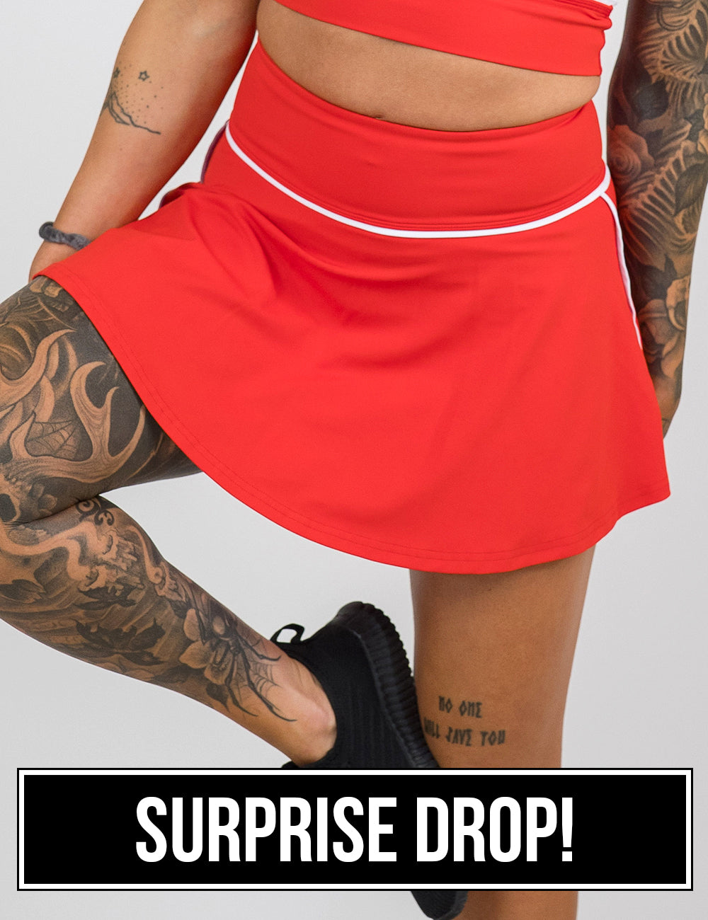front of the regular length red skirt with white accents against a white background, surprise drop