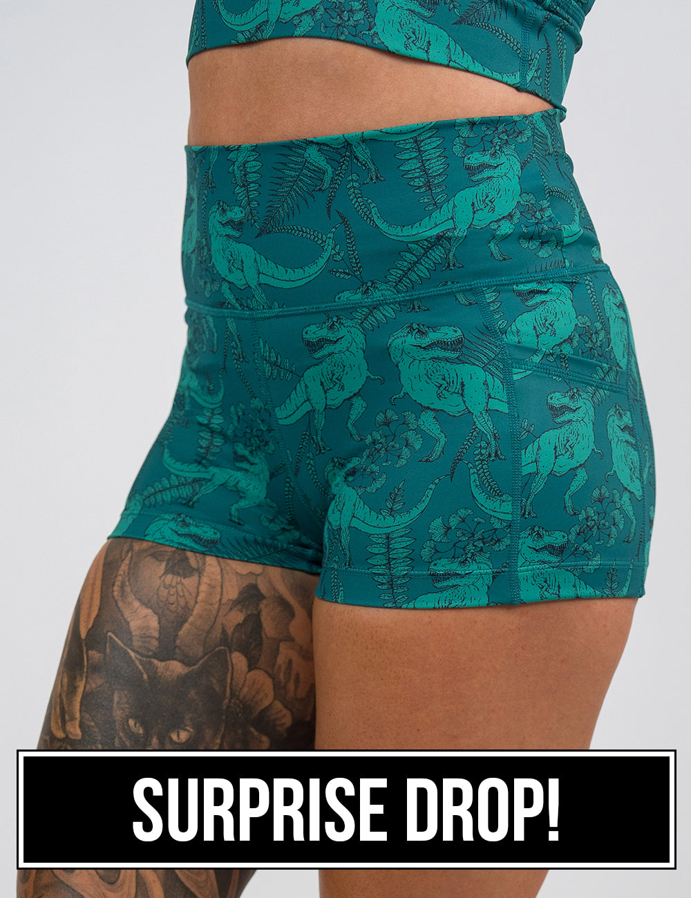 front of the 2.5 inch teal t-rex shorts against a white background, surprise drop