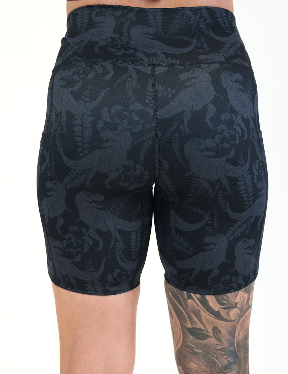 back of the black on black dinosaur printed shorts 7 inch against a white background