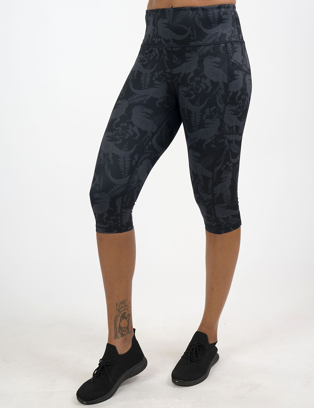 cropped black leggings with grey dinosaur pattern