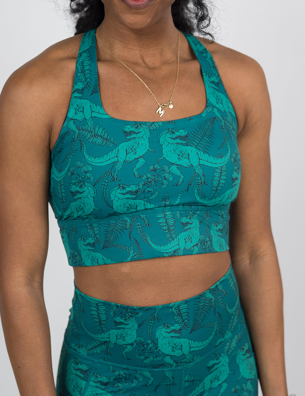 front of the teal t-rex longline bra against a white background