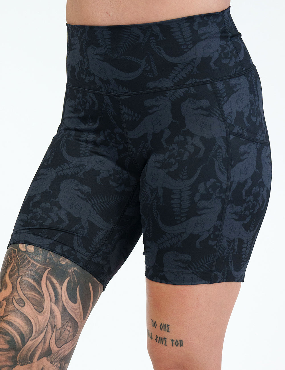 front of the 7 inch black on black dinosaur printed shorts against a white background