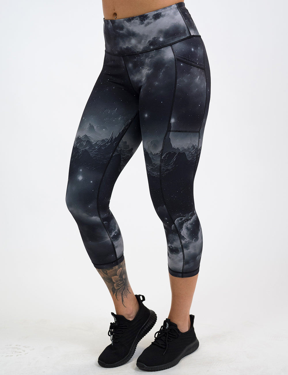 model wearing the capri black leggings with mountain and star pattern against a white background