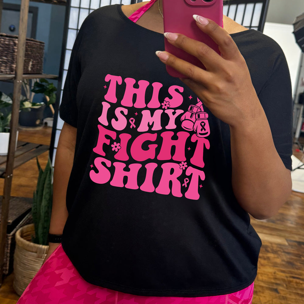 black t-shirt with pink text 'This is my fight shirt' on a white background