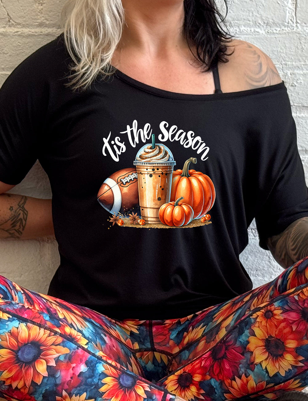 shirt with a football, coffee and pumpkin graphic on it with the quote "tis the season" on it