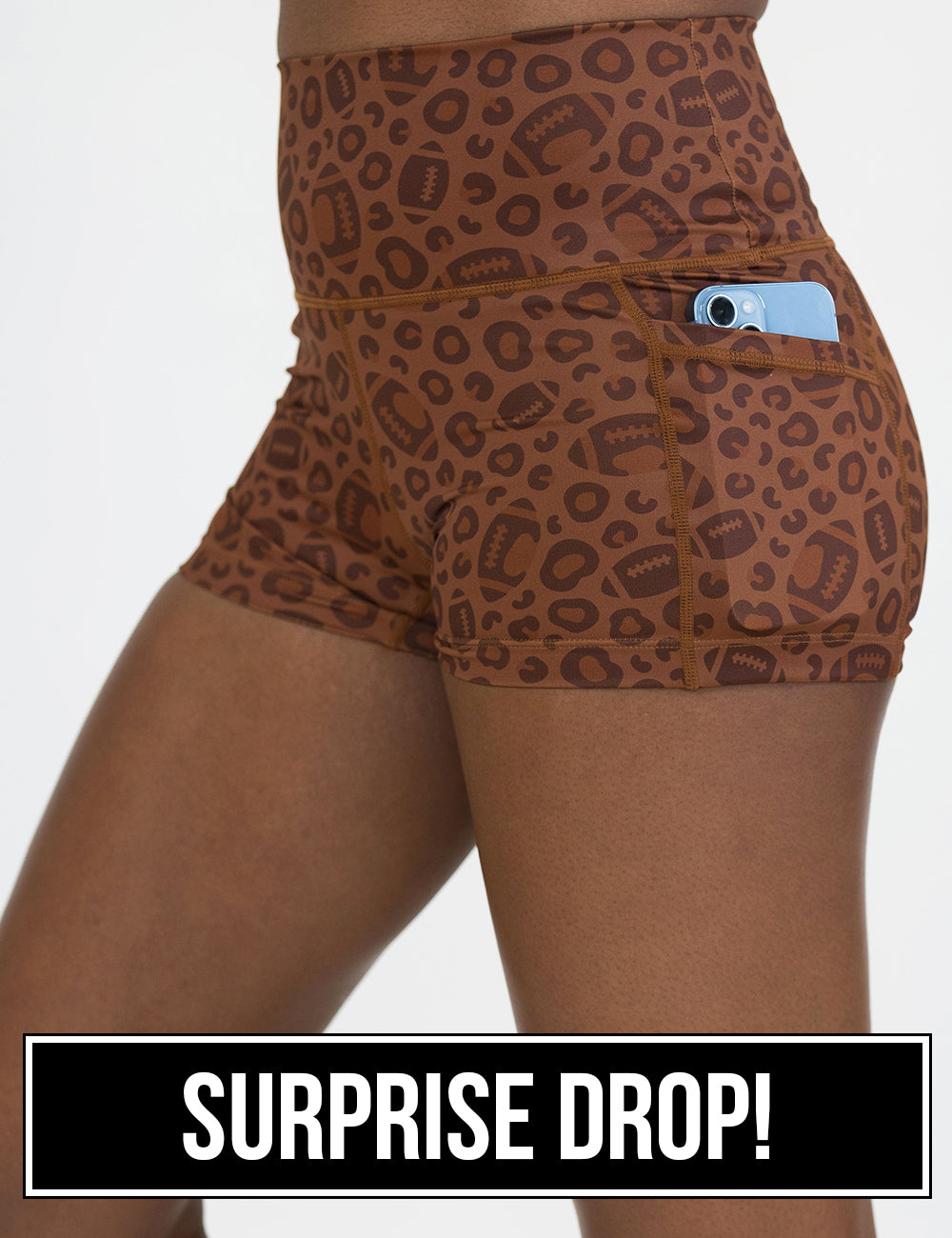 close up of the football themed brown leopard print 2.5 inch shorts with a phone in its pocket, surprise drop