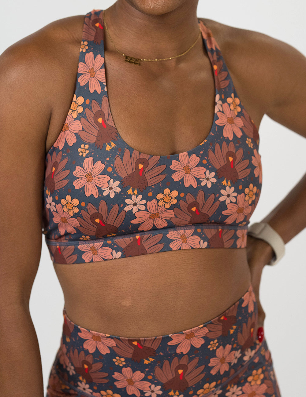 front of the turkeys over a blue background sports bra against a white background