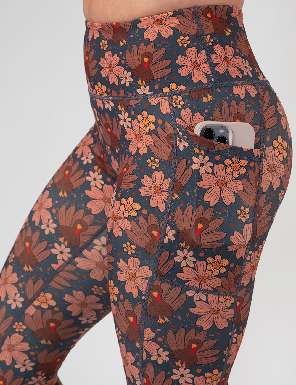 close up of the turkeys over a blue background leggings with a phone in its pocket