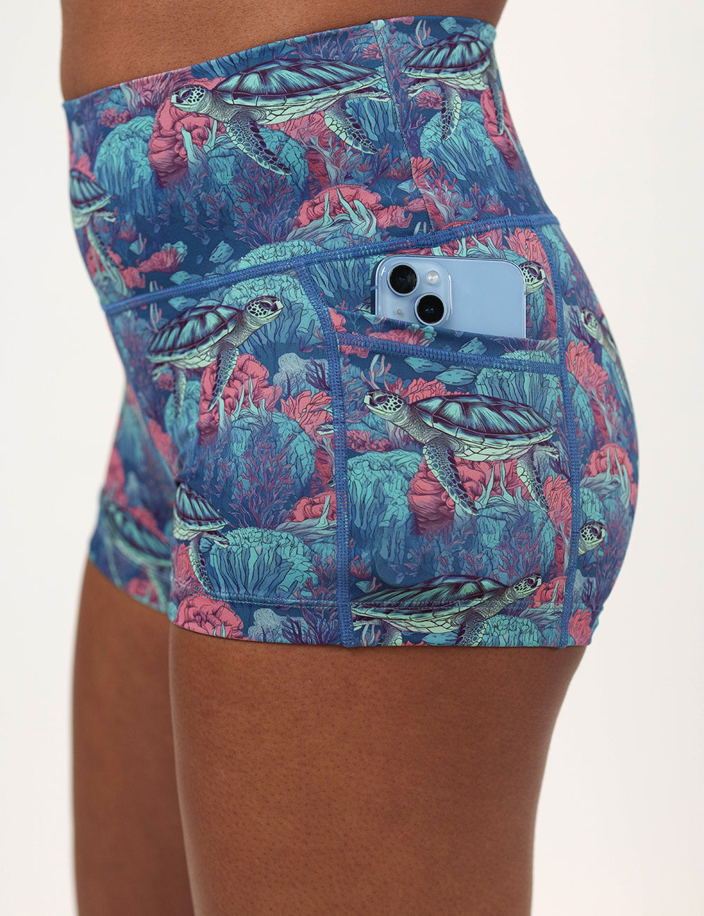 close up of the 2.5 inch turtle patterned shorts with a phone in its pocket
