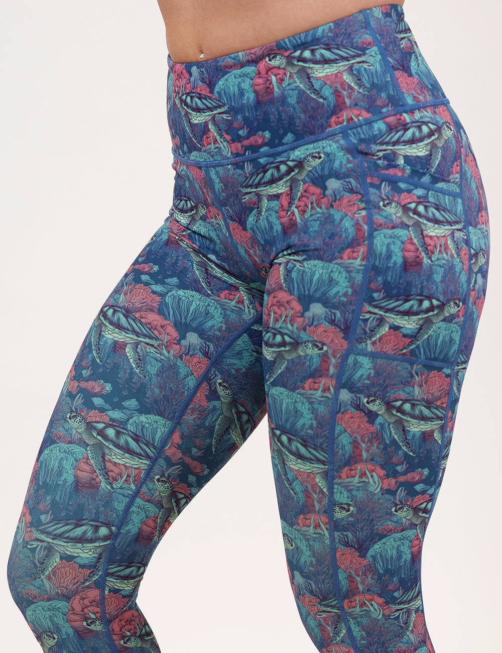 front of the turtle patterned leggings against a white background