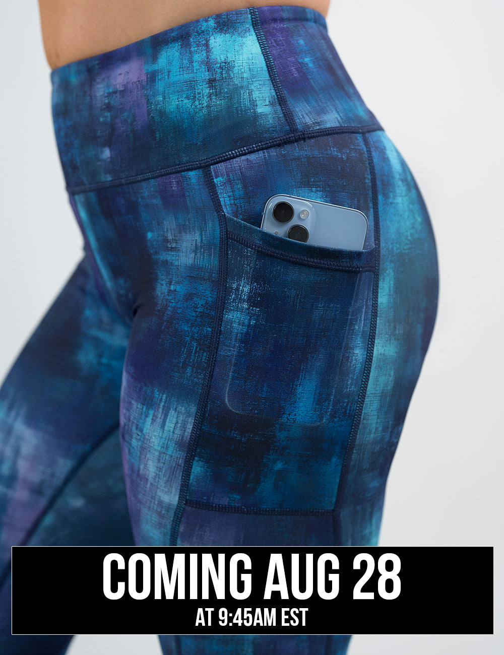 close up of the blue, teal, and purple grunge concrete pattern legging with a phone in its pocket, coming august 28th