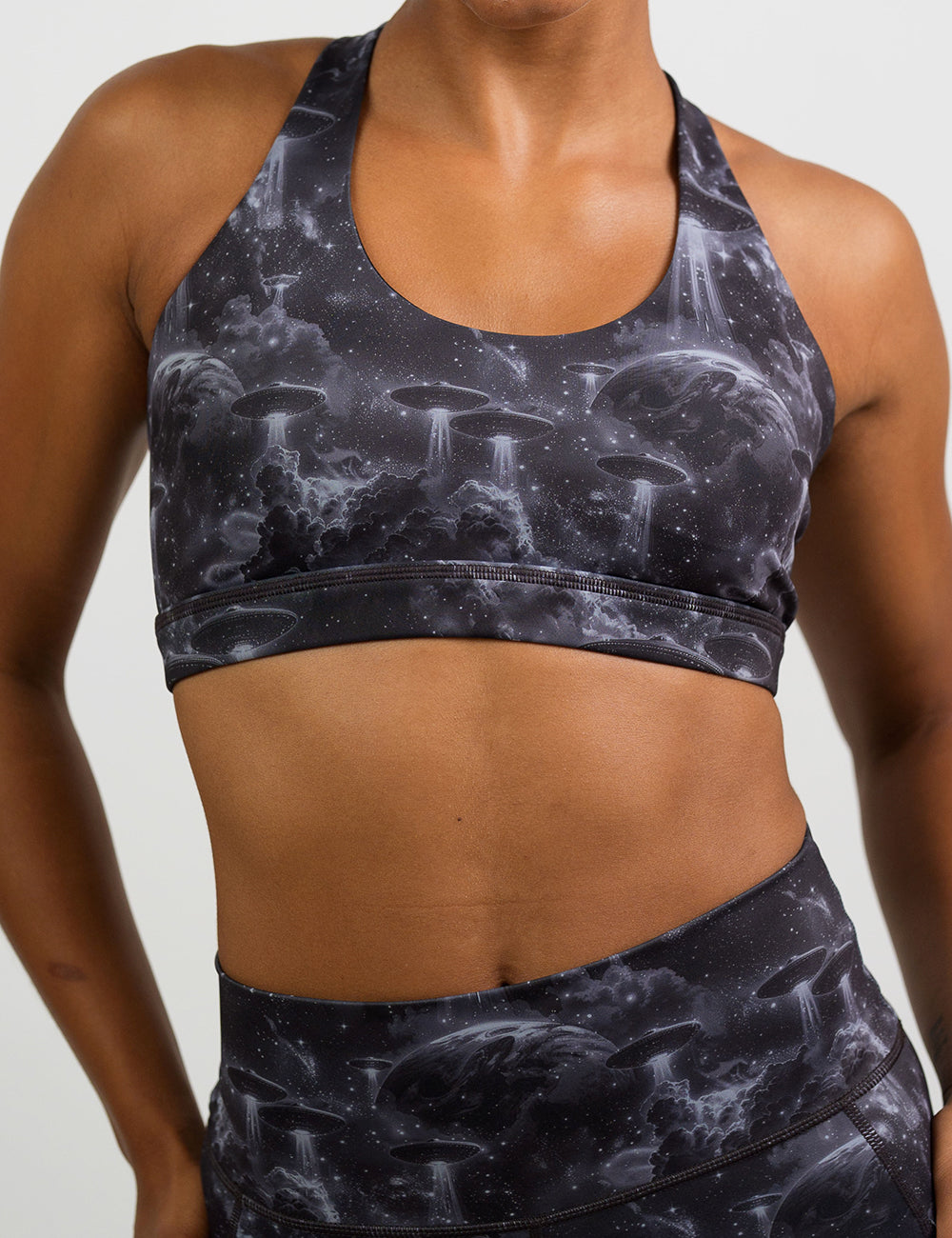 front of the alien space ship invasion sports bra against a white background