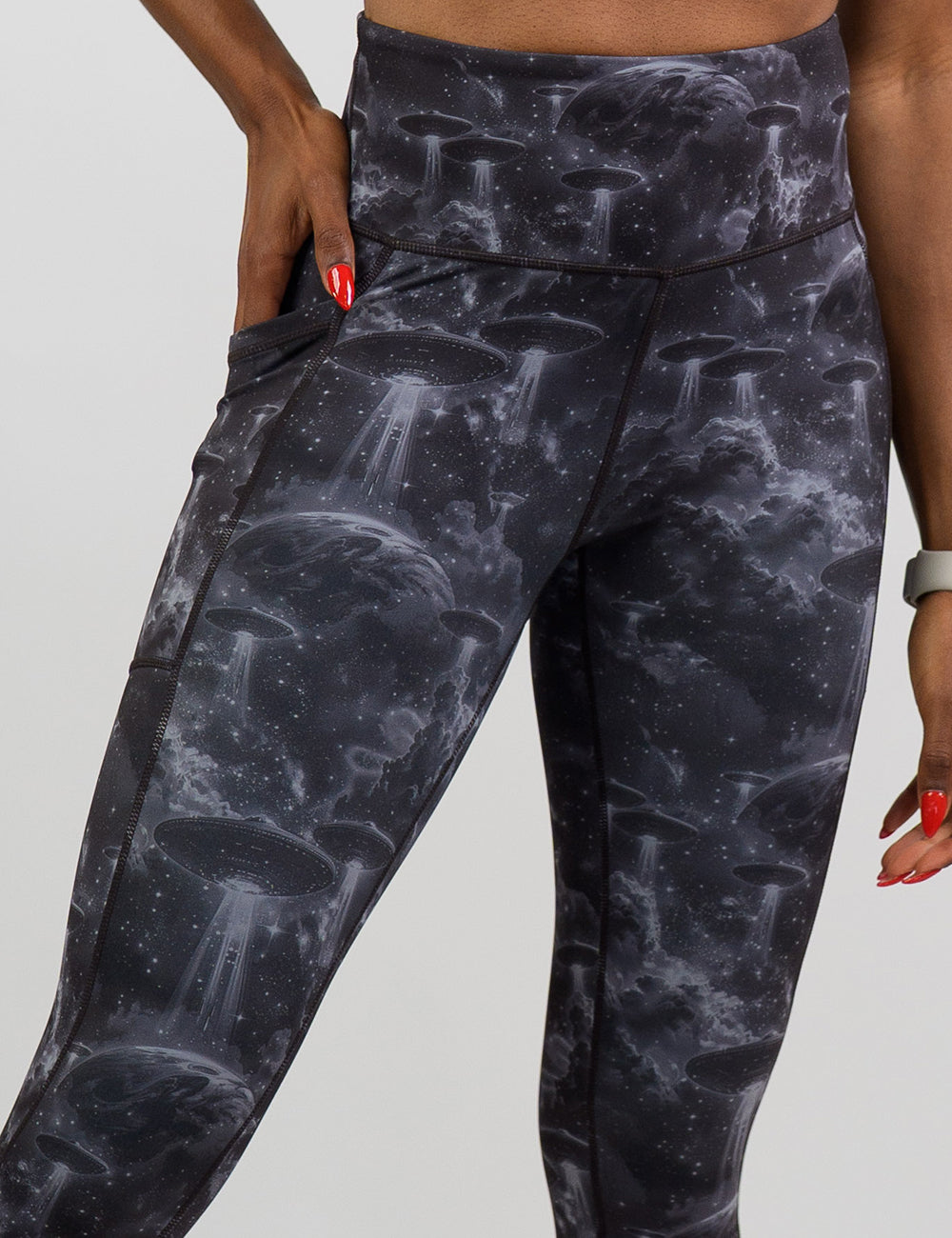 front of the alien space ship invasion leggings against a white background