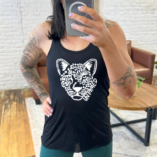 model wearing black tank top with tiger head design saying untamed on it