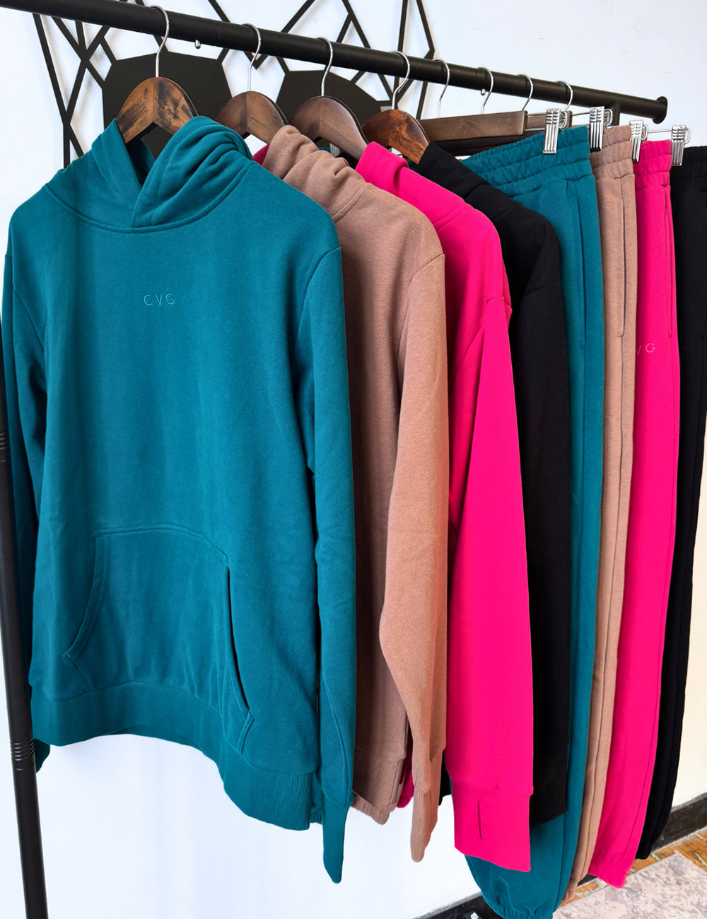 all four colors of the unwind hoodies and sweatpants on a clothing rack