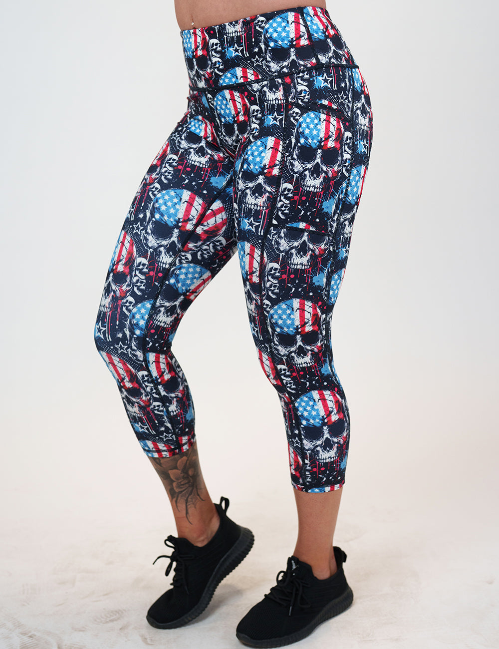 front of the capri black leggings with american flag skulls against a white background