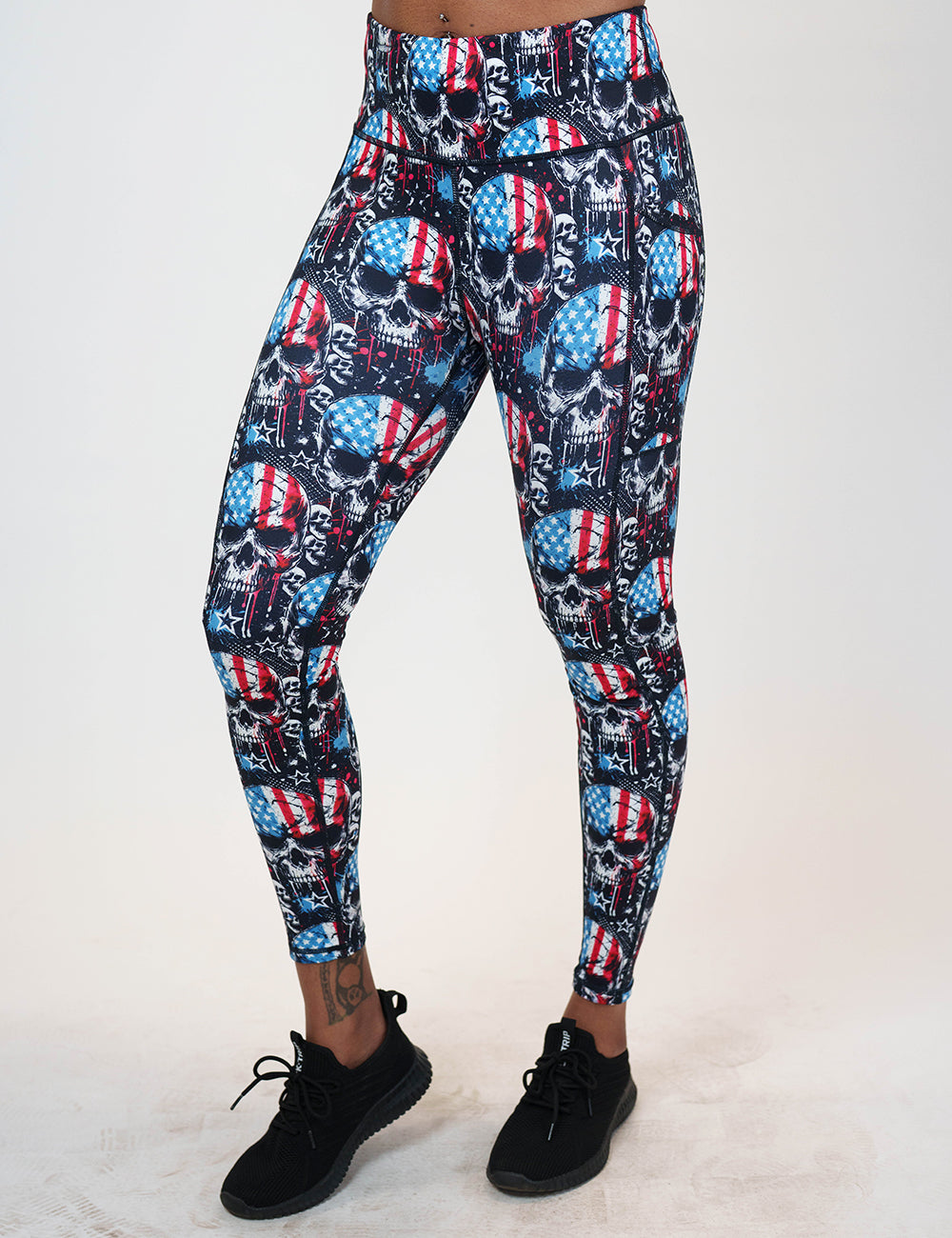 front of the full length black leggings with american flag skulls against a white background