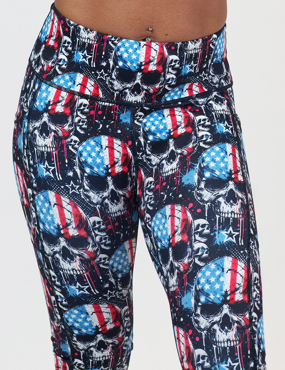 front of the black leggings with american flag skulls against a white background