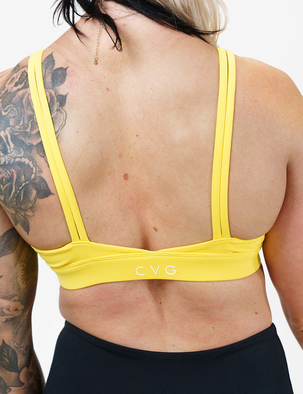 back of the solid yellow sports bra