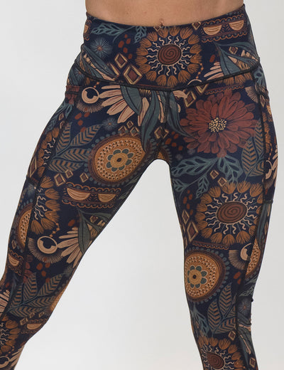 front of the paisley flowers leggings against a white background