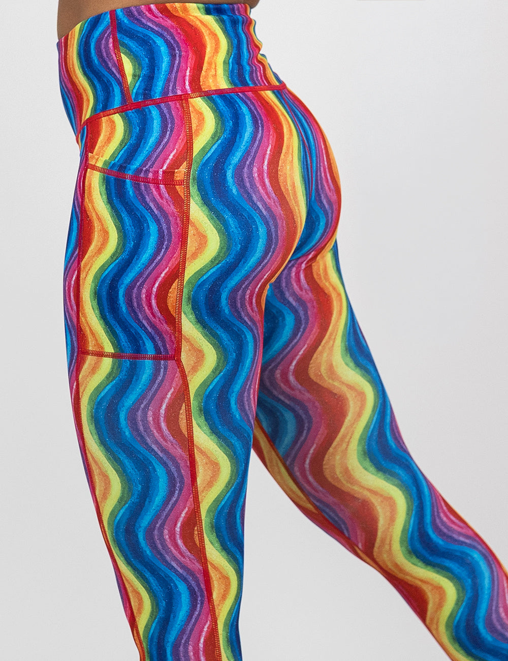 side of the rainbow waves leggings against a white background