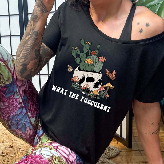 model wearing the black slouchy shirt with a plant graphic with the saying "what the fucculent" on it in white