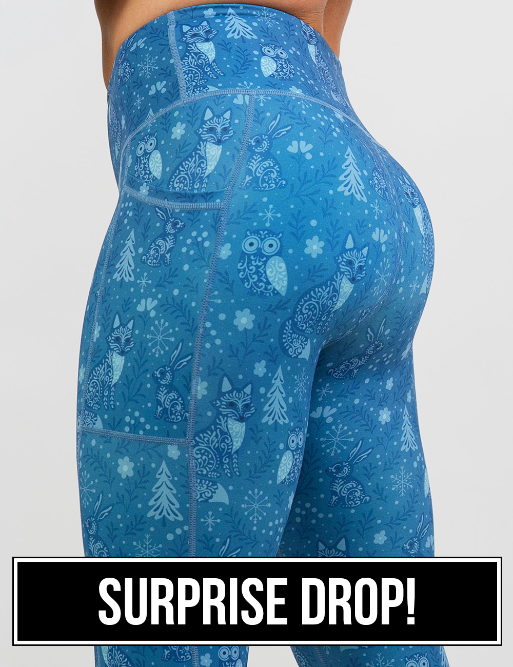back of the blue foxes, owls, and bunnies in a winter landscape leggings, surprise drop