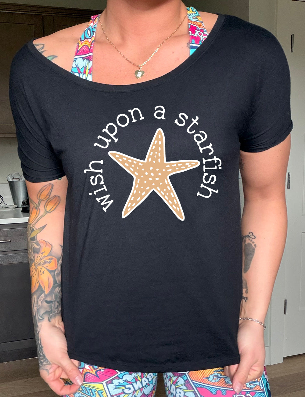 black slouchy tee with the graphic of a starfish, and the words arched around it saying "wish upon a starfish"