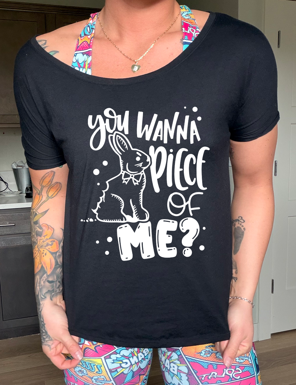black slouchy tee with the words "you wanna piece of me?" on it with the graphic of a bunny with a chomp taken out of its behind