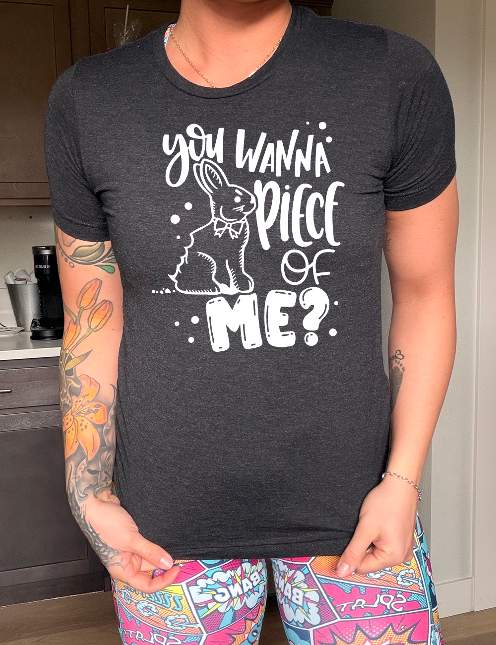 black unisex tee with the words "you wanna piece of me?" on it with the graphic of a bunny with a chomp taken out of its behind