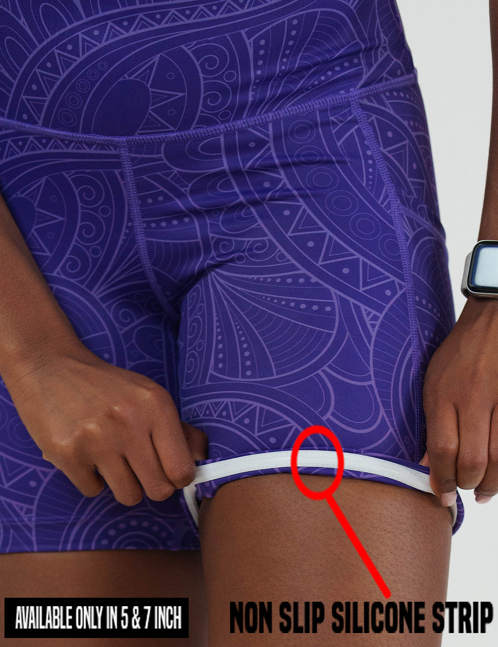 close up of the purple with a white swirl pattern shorts rolled up to show the non slip silicone strip lining found in the 5 and 7 inch shorts