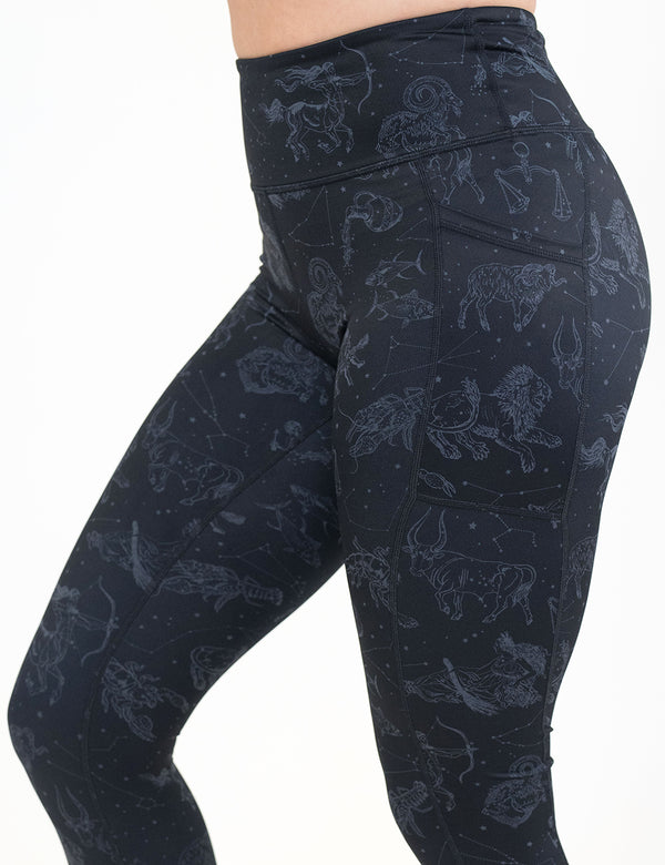 front of the black leggings with constellations on them against a white background