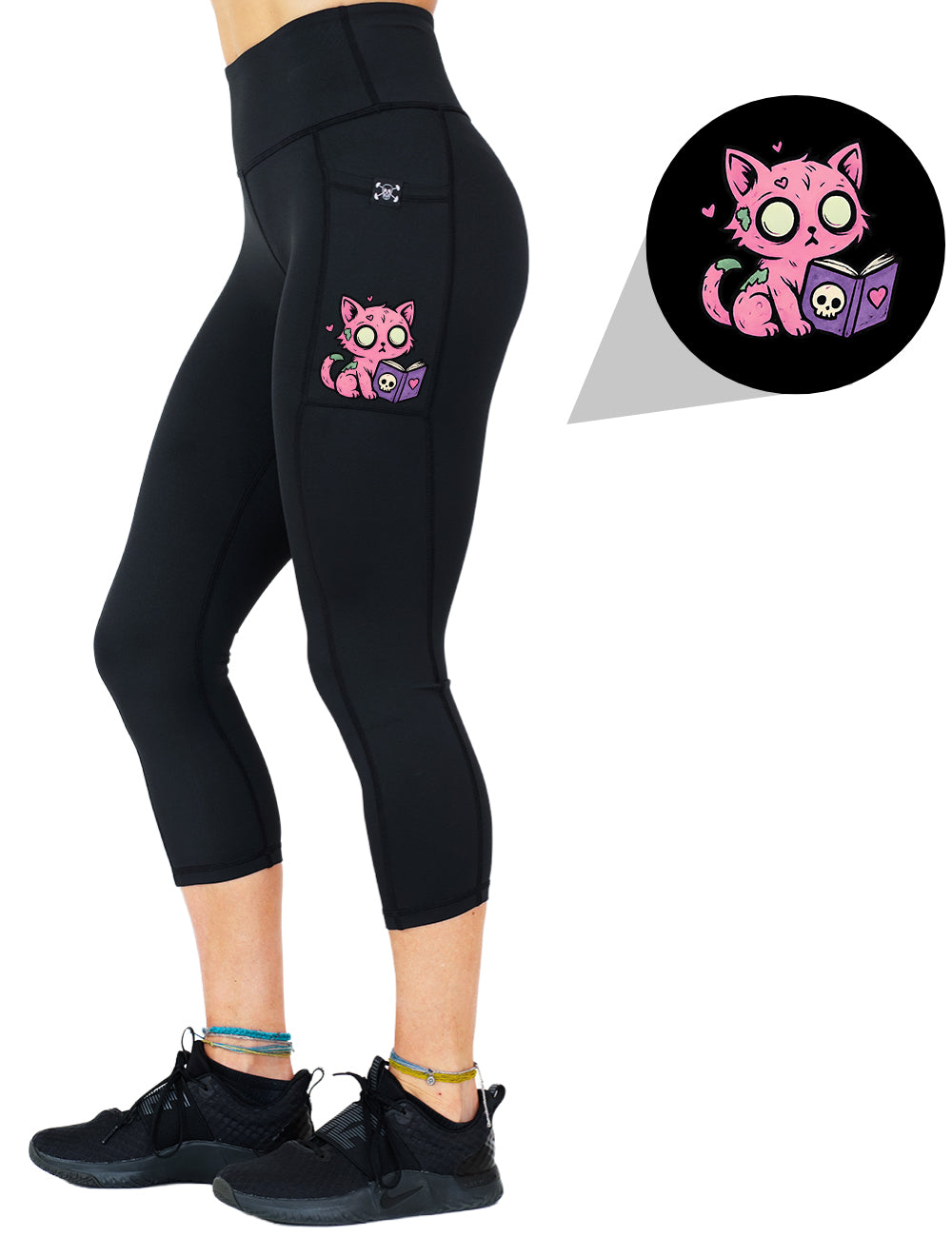 front of the zombie cat reading a book graphic capri leggings