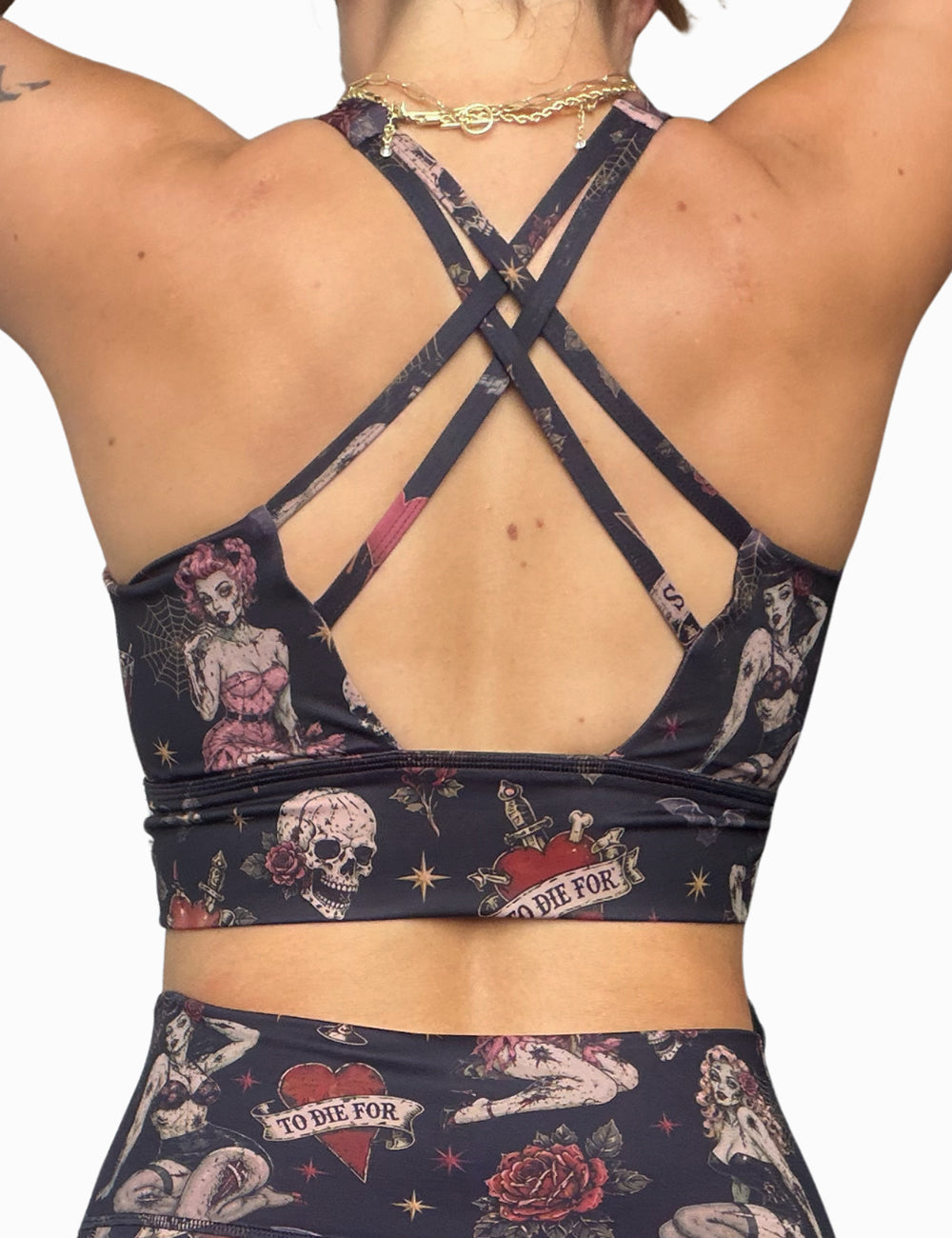 back of the zombie girls with pin up hair and traditional tattoo designs bra against a white background