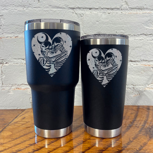 30oz and 20oz black tumblers with skeletons, the moon and stars in a heart