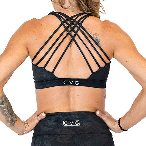 back view of black on black skull design sports bra