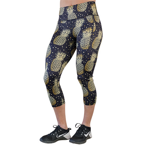 capri length black leggings with gold pineapple pattern