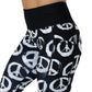 close up of black and white peace sign print leggings