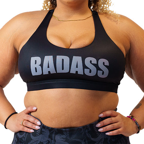front view of black sports bra with the word "badass" on it in grey