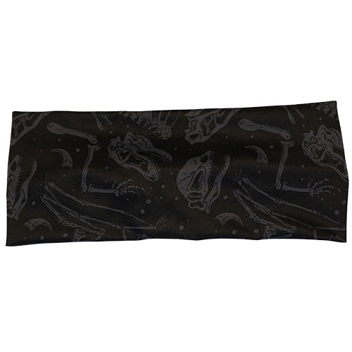 front view of black headband with grey dinosaur skull and bones detail