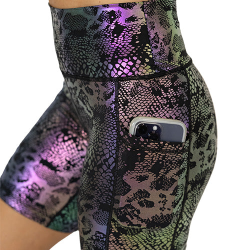 close up pocket view of black, purple and green holographic shorts 