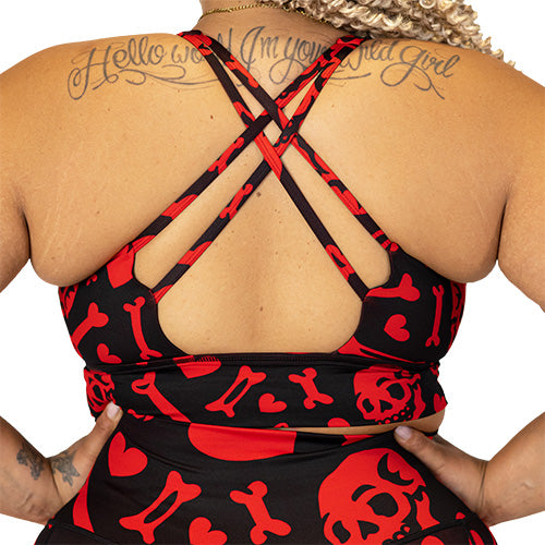 back view of double strap cross back red and black bra with skulls, bones and hearts