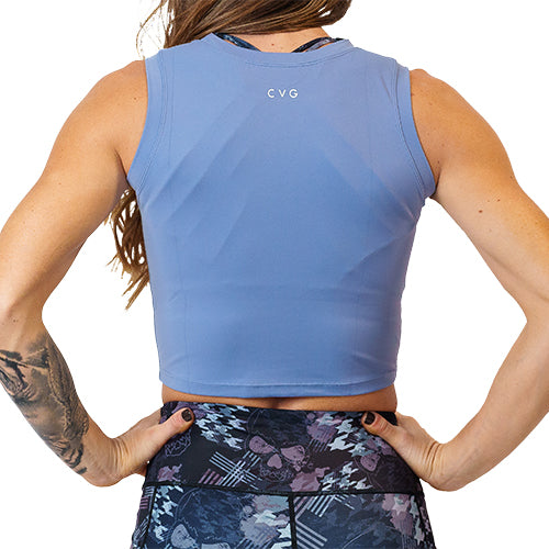 Close up photo of the back of a model wearing a blue fitted crop top