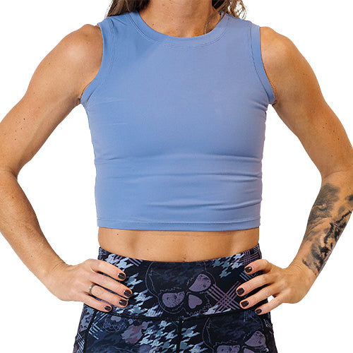 Close up photo of a model wearing a blue fitted crop top