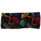 front view of black headband with yellow, red, blue and white dinosaur skull and bones detail